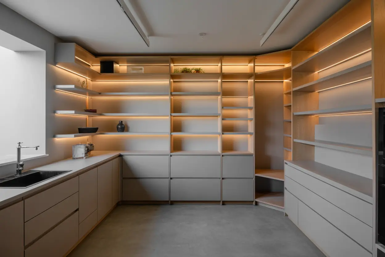Modern white lacquer concealed walk-in pantry with pull-out systems and coffee station in Tribeca Manhattan loft