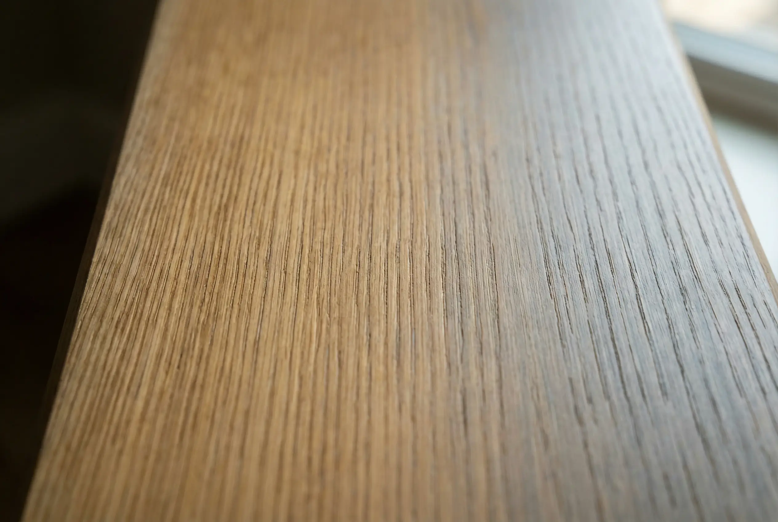 Close-up of quarter-sawn white oak grain pattern with oil finish on custom millwork