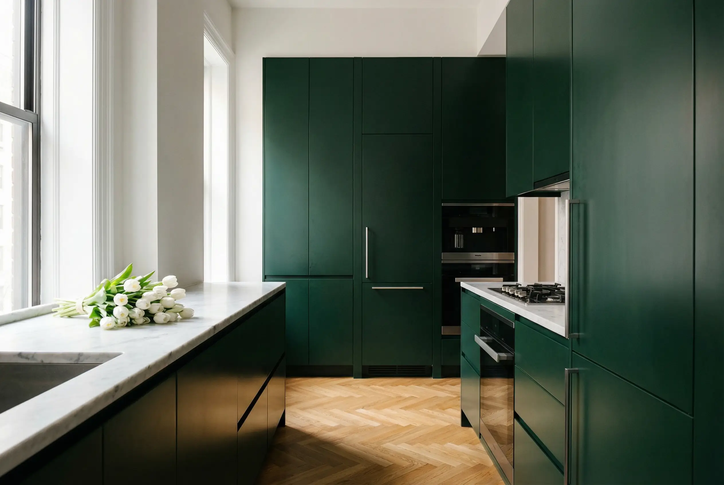 European minimalist integrated kitchen forest green lacquer with hidden Miele appliances in Upper West Side Manhattan apartment