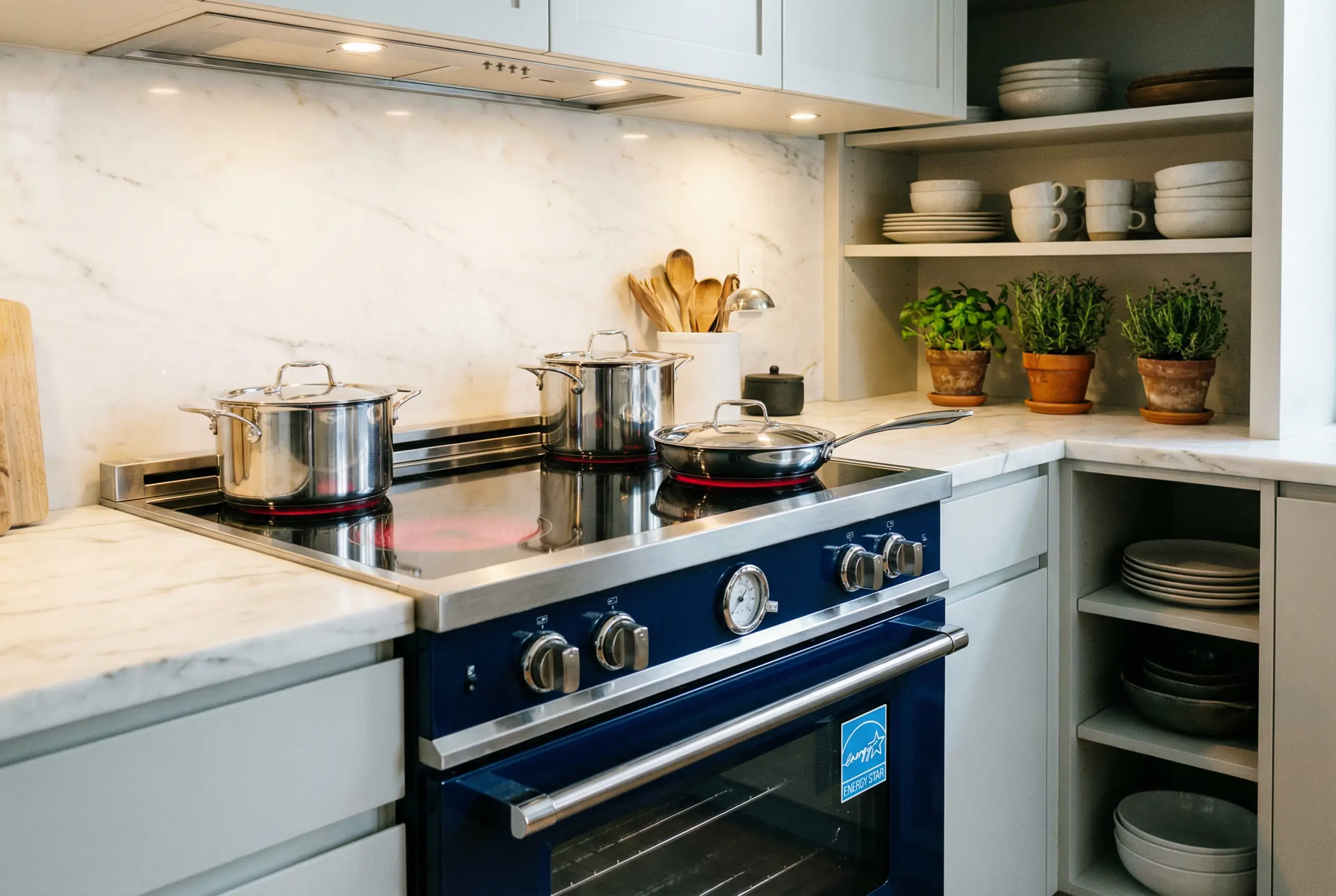 Energy Star 2026 compliant induction range in high-end Manhattan kitchen renovation with marble countertops