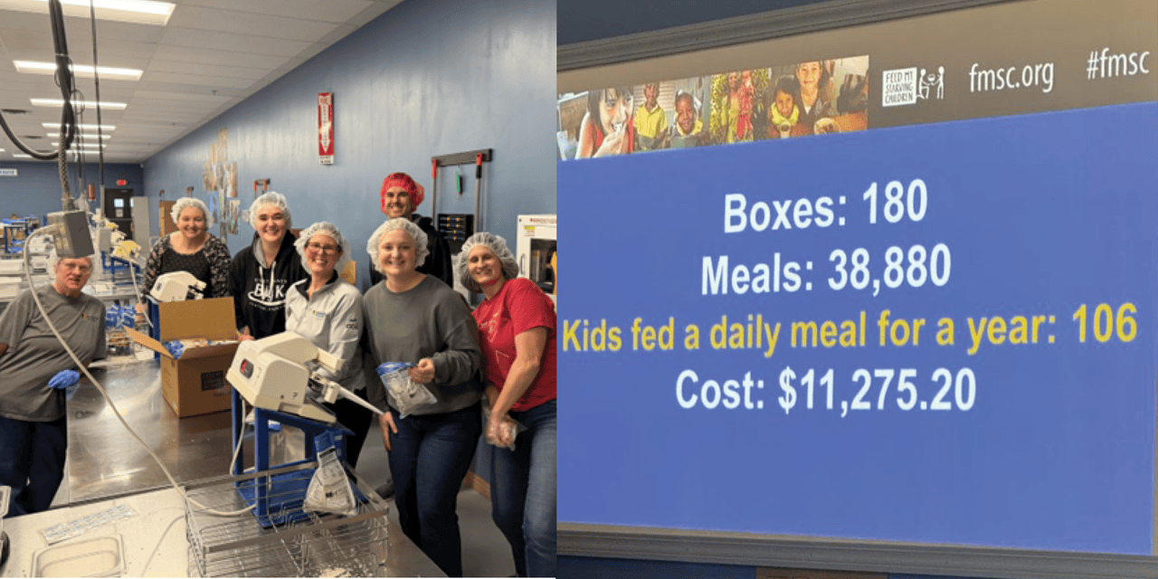Associa Minnesota team members volunteering at Feed My Starving Children, packing meals and celebrating their impact on children in need.