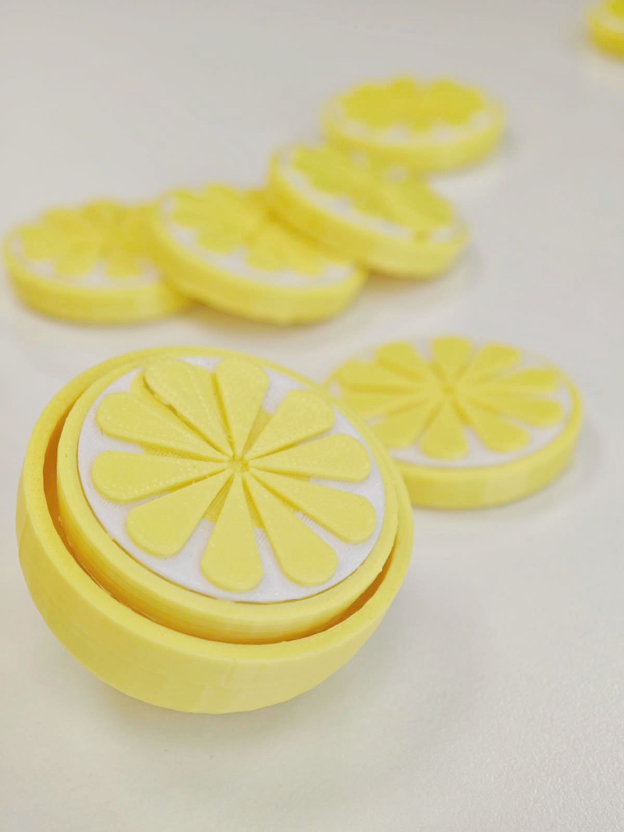 Yellow lemon-shaped clickers made through 3D printing
