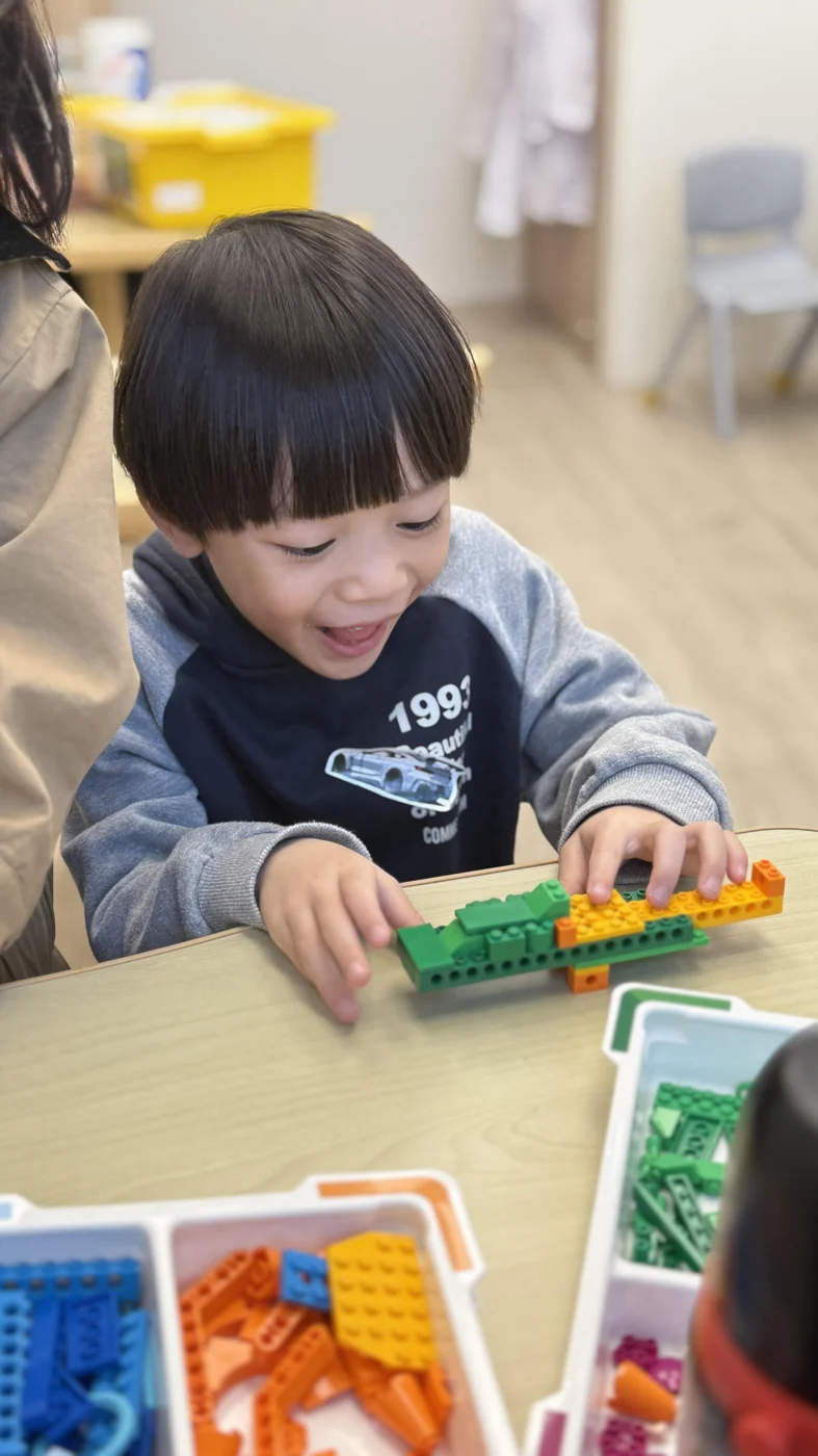 A young learner connecting pieces in a LEGO model