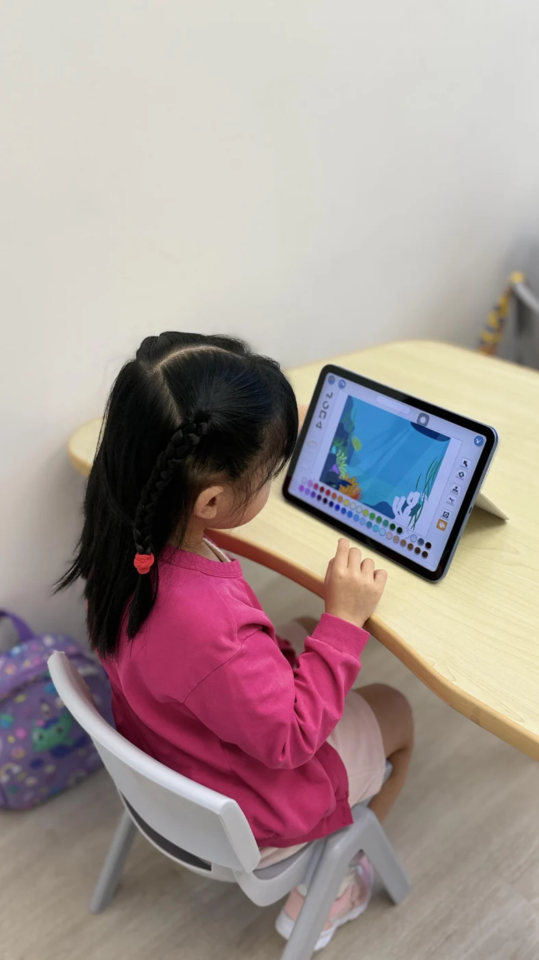 A student creating a game on a tablet