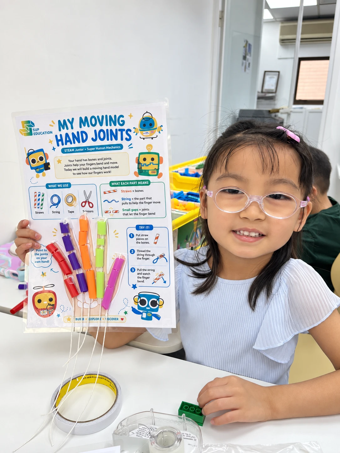 A student presenting her moving hand-joints model
