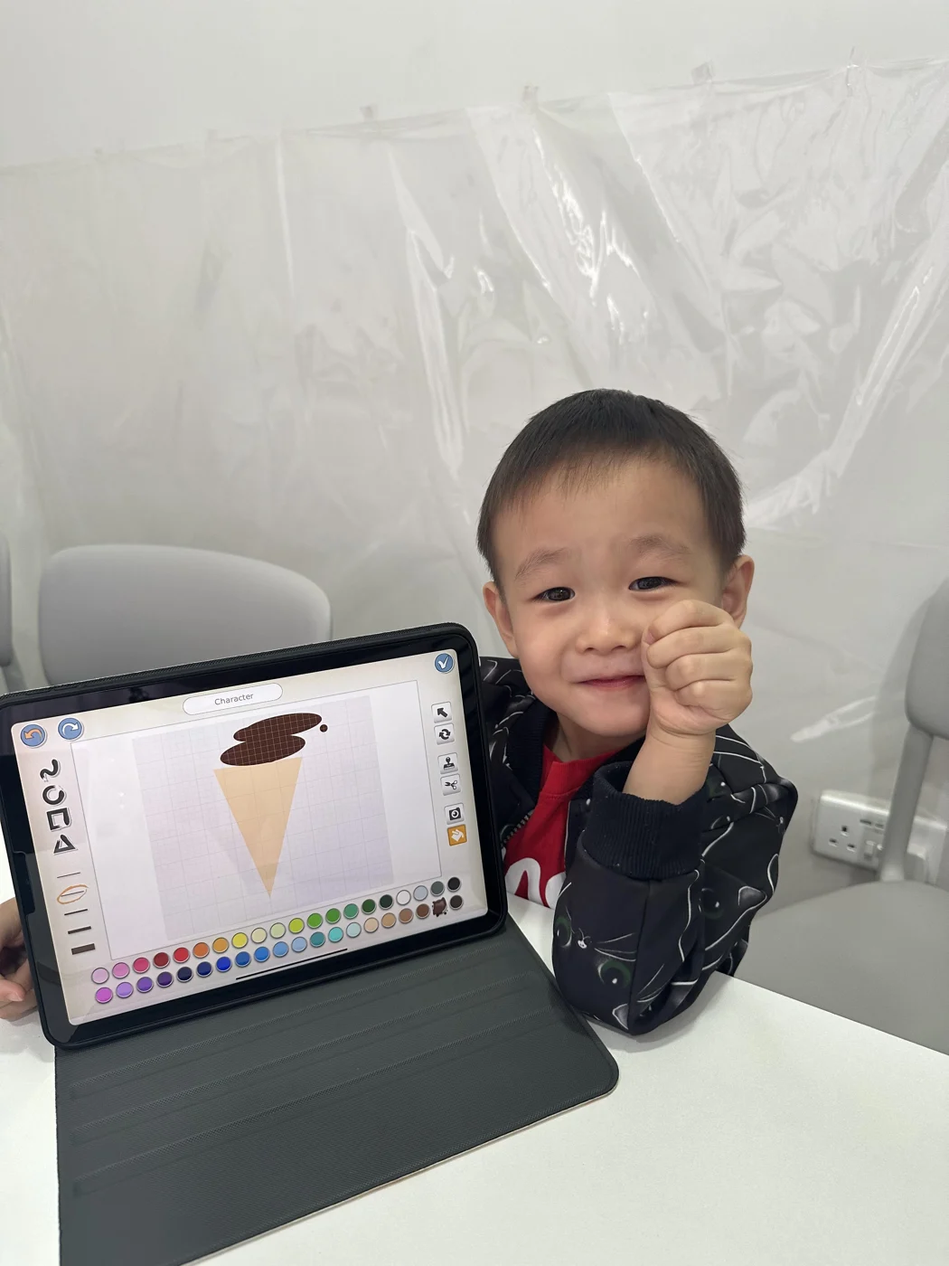 A student with a character design on a tablet
