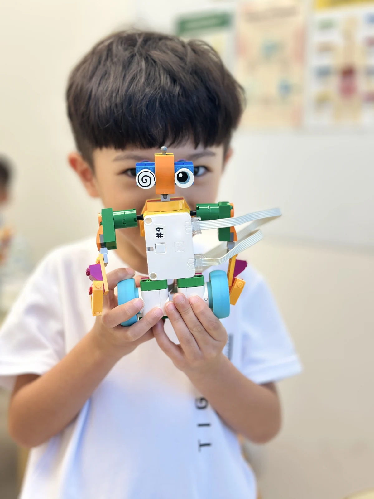 A SUP student holding a colourful LEGO creation