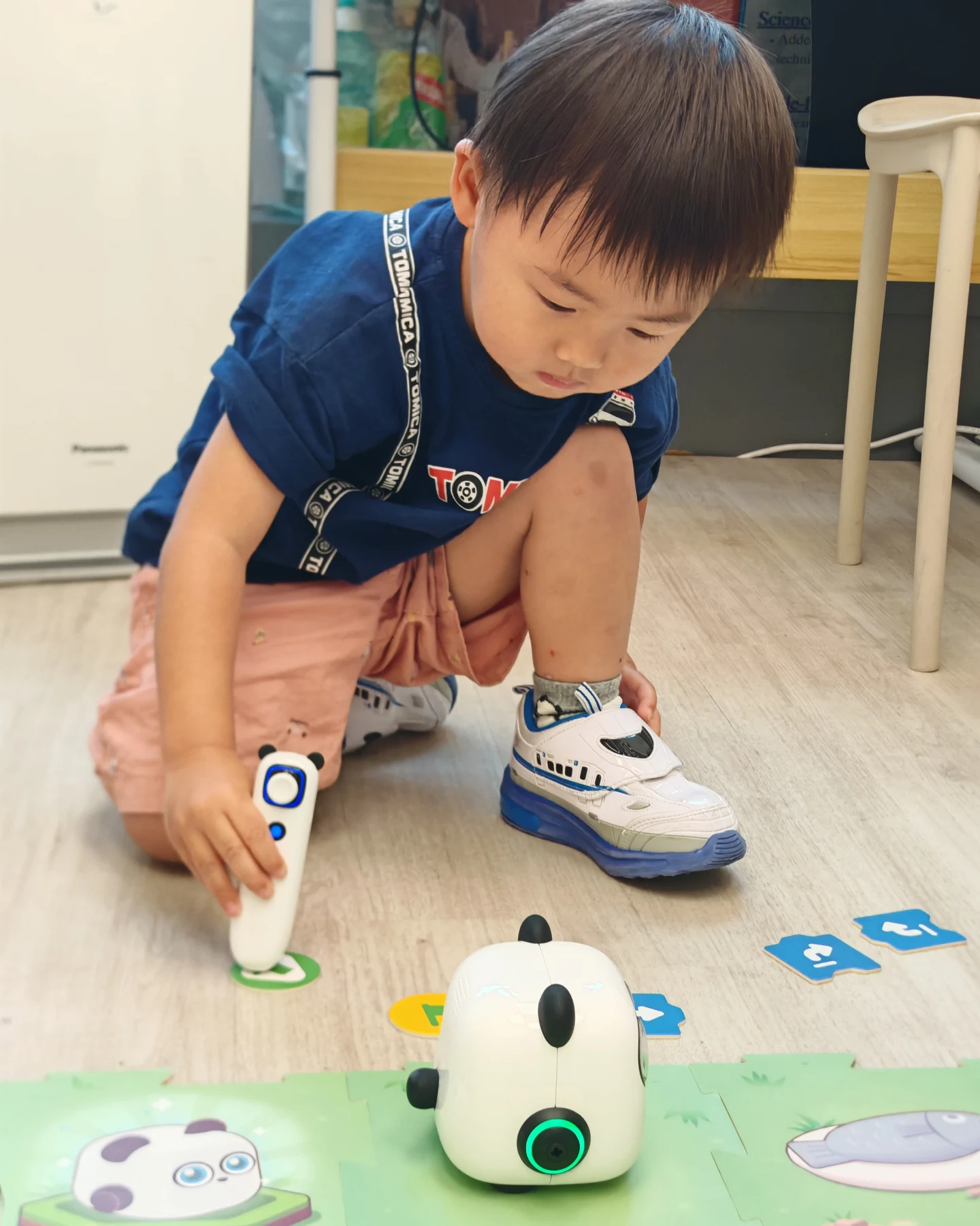 A child guiding mTiny using physical coding commands