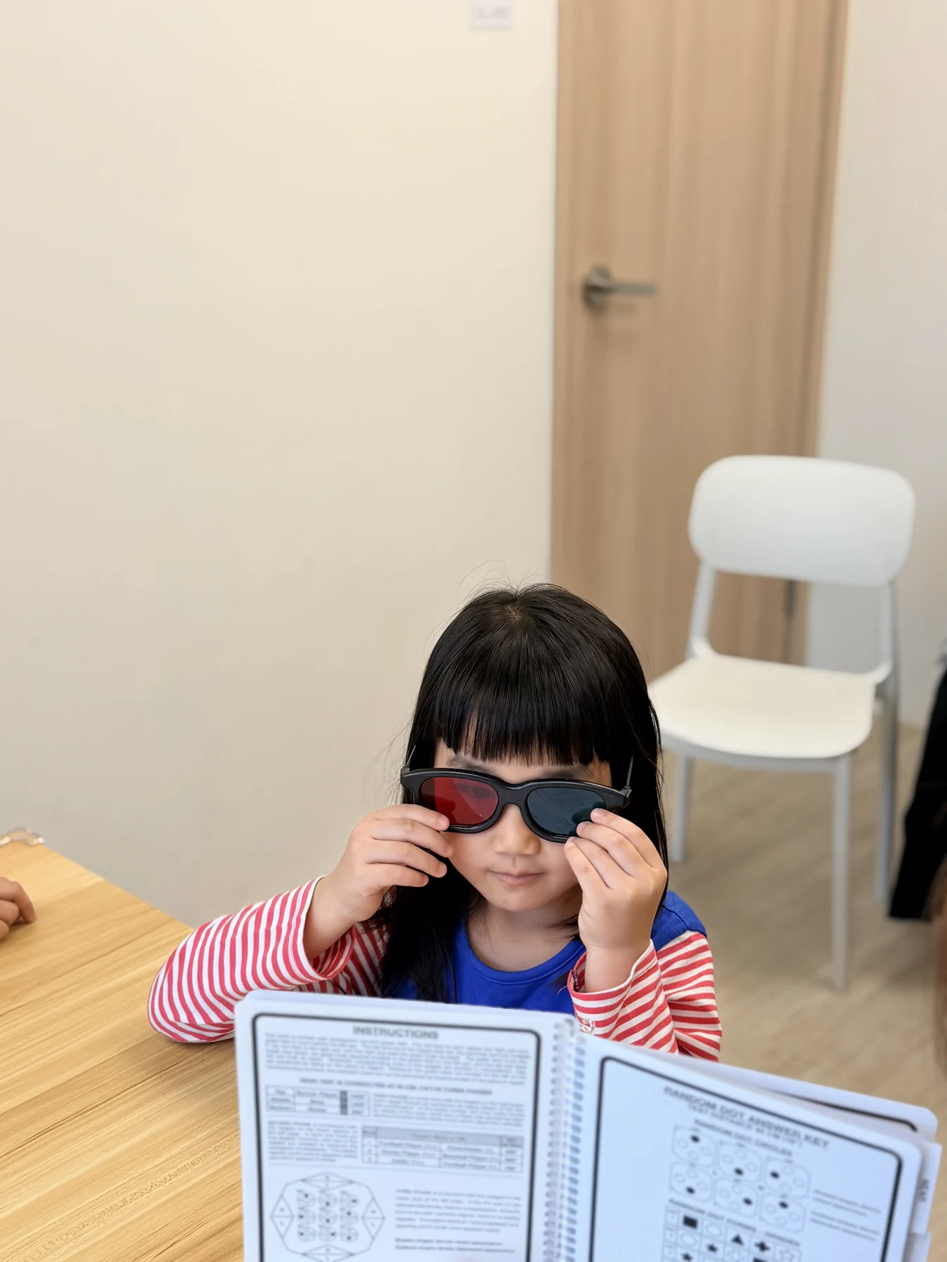 A child using coloured glasses during a guided visual activity