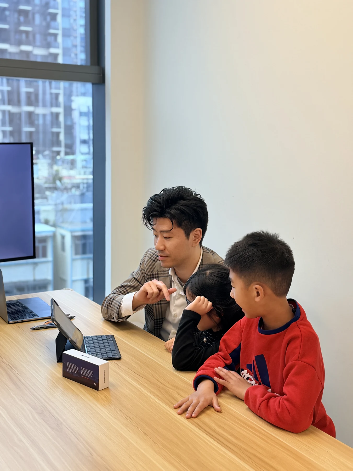 Jeff guiding a child through a tablet-based visual activity