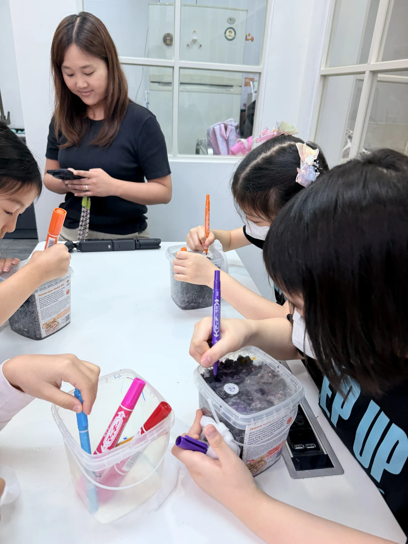 Students exploring mushroom growing and preparing take-home kits at Myconoko Lab