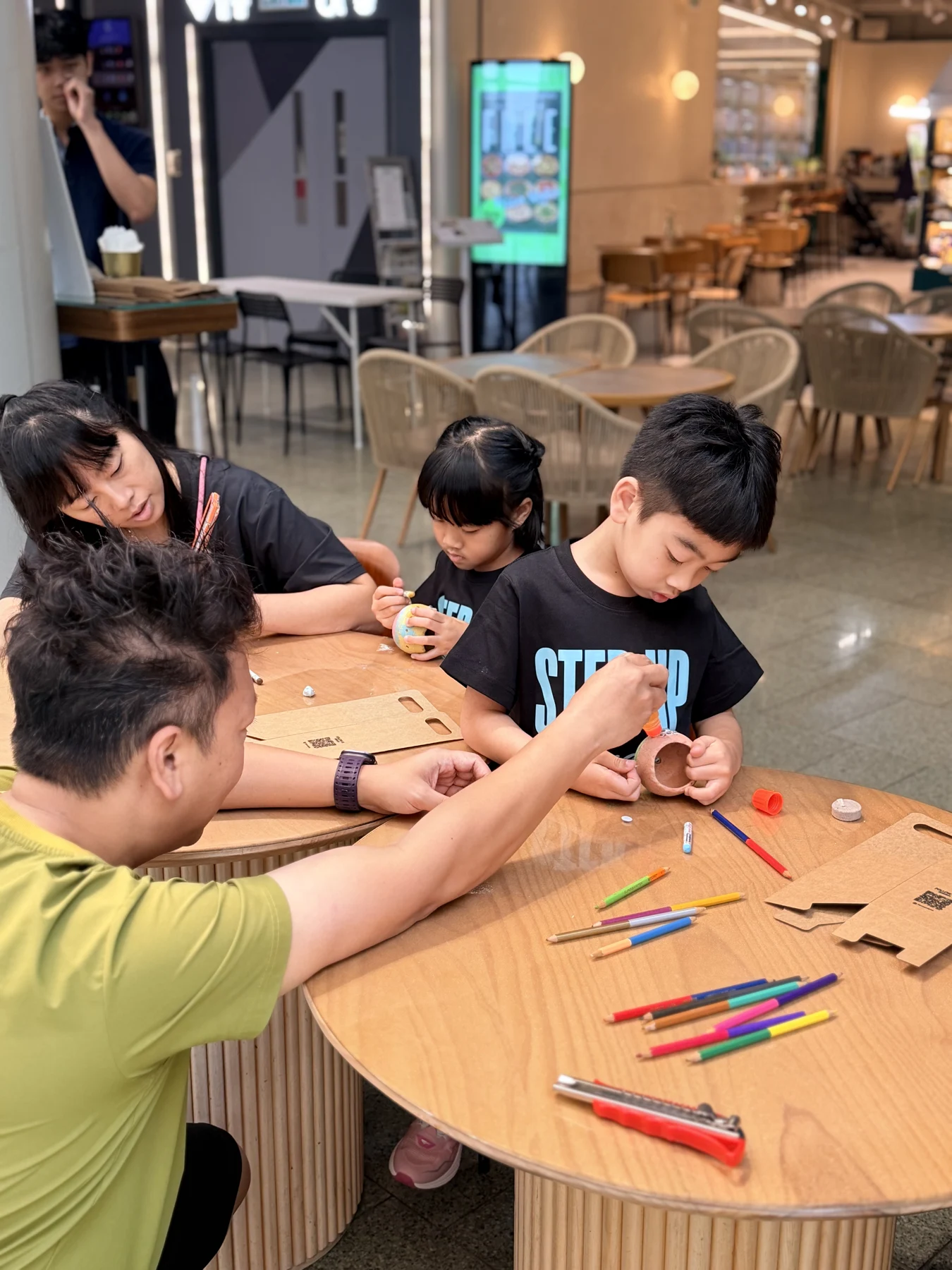 Parents and children exploring food and growing at SEED by Farmacy, Cyberport