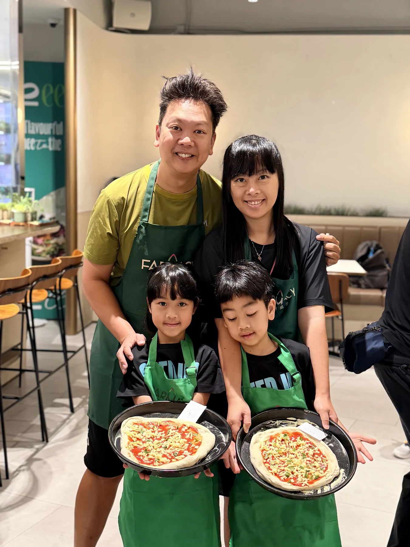 Families preparing or sharing their pizzas at SEED by Farmacy