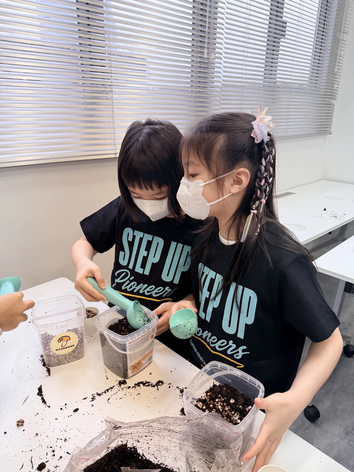 Students exploring mushroom growing and preparing take-home kits at Myconoko Lab