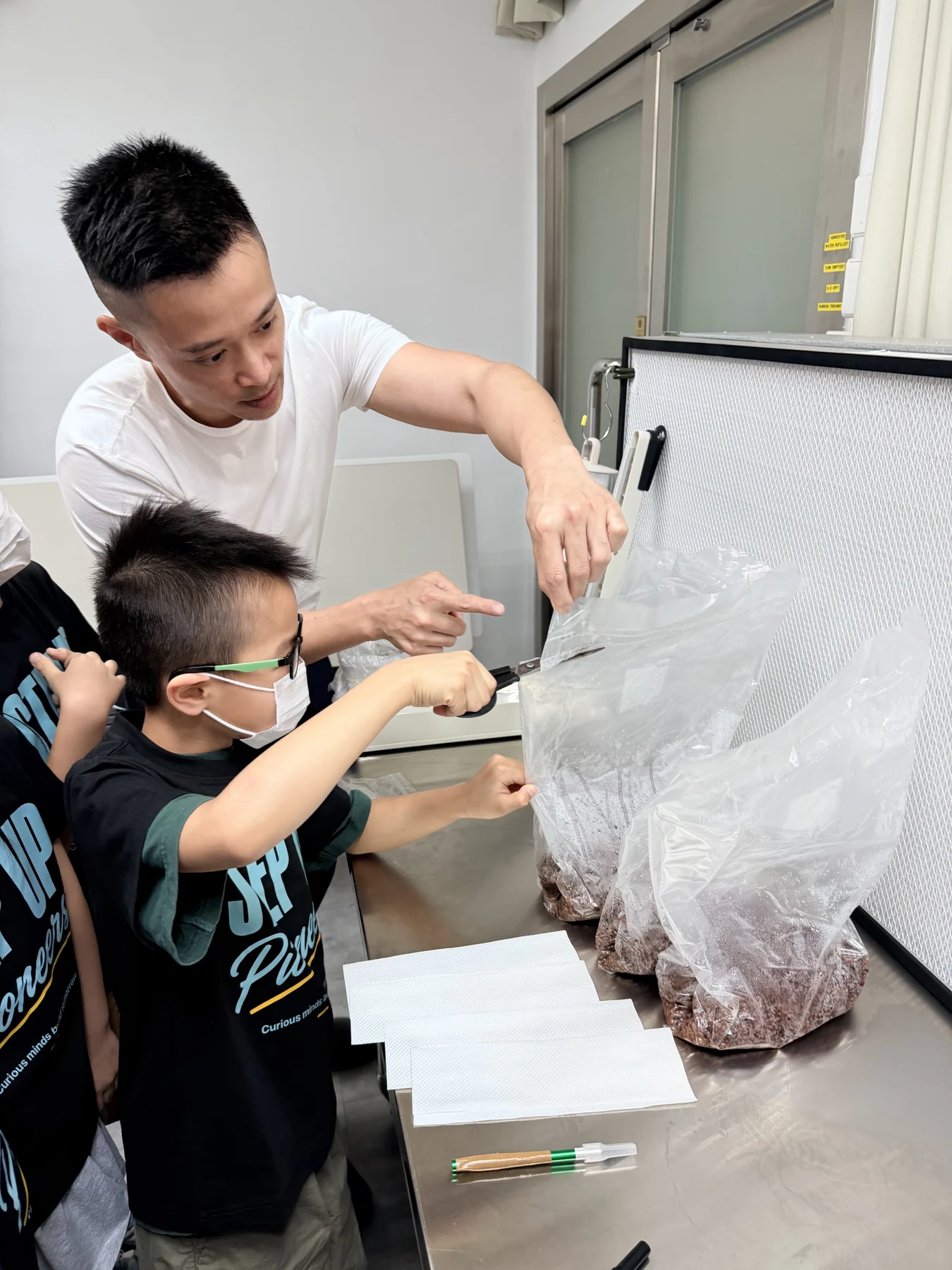 Students exploring mushroom growing and preparing take-home kits at Myconoko Lab