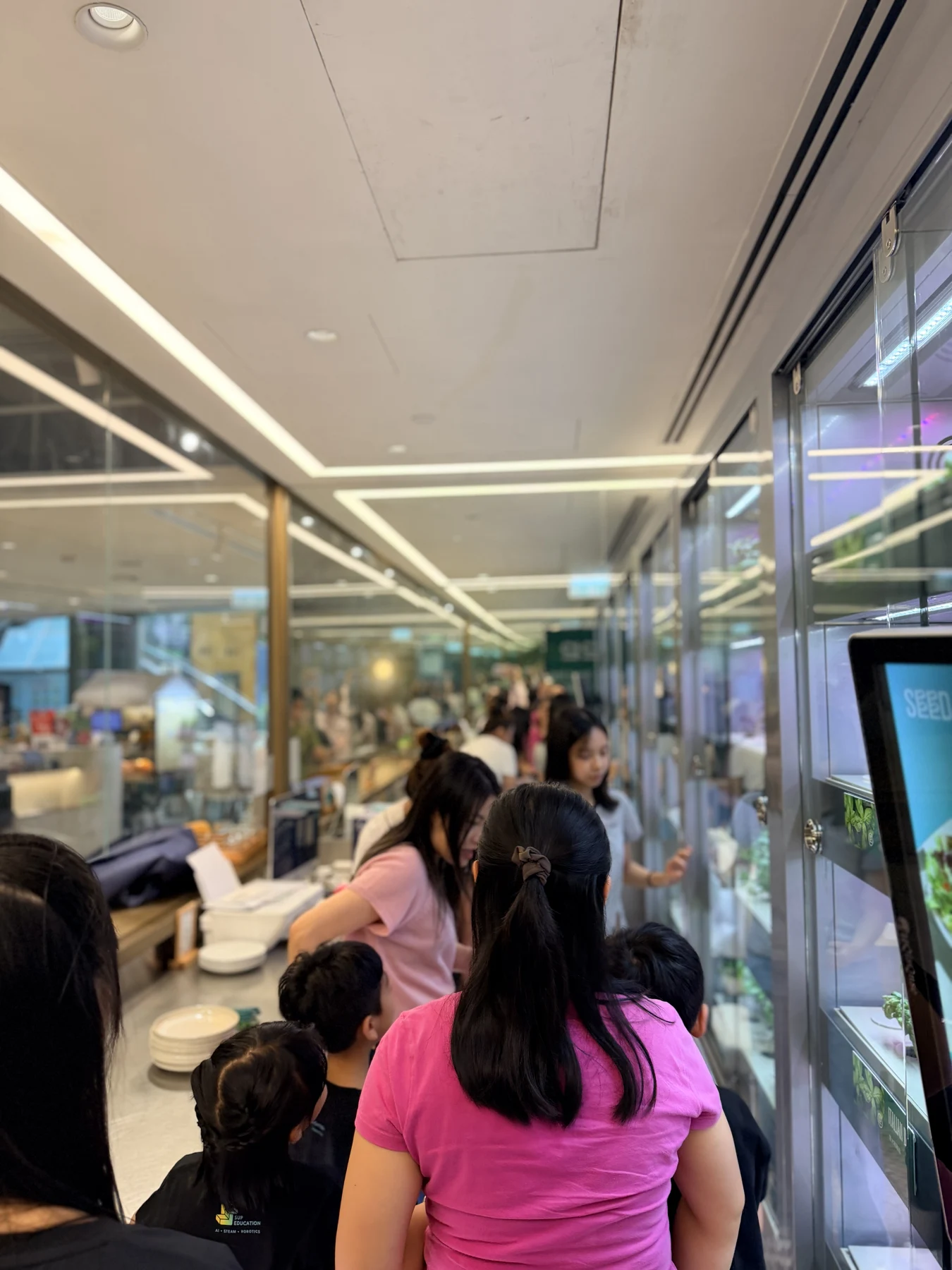 Parents and children exploring food and growing at SEED by Farmacy, Cyberport