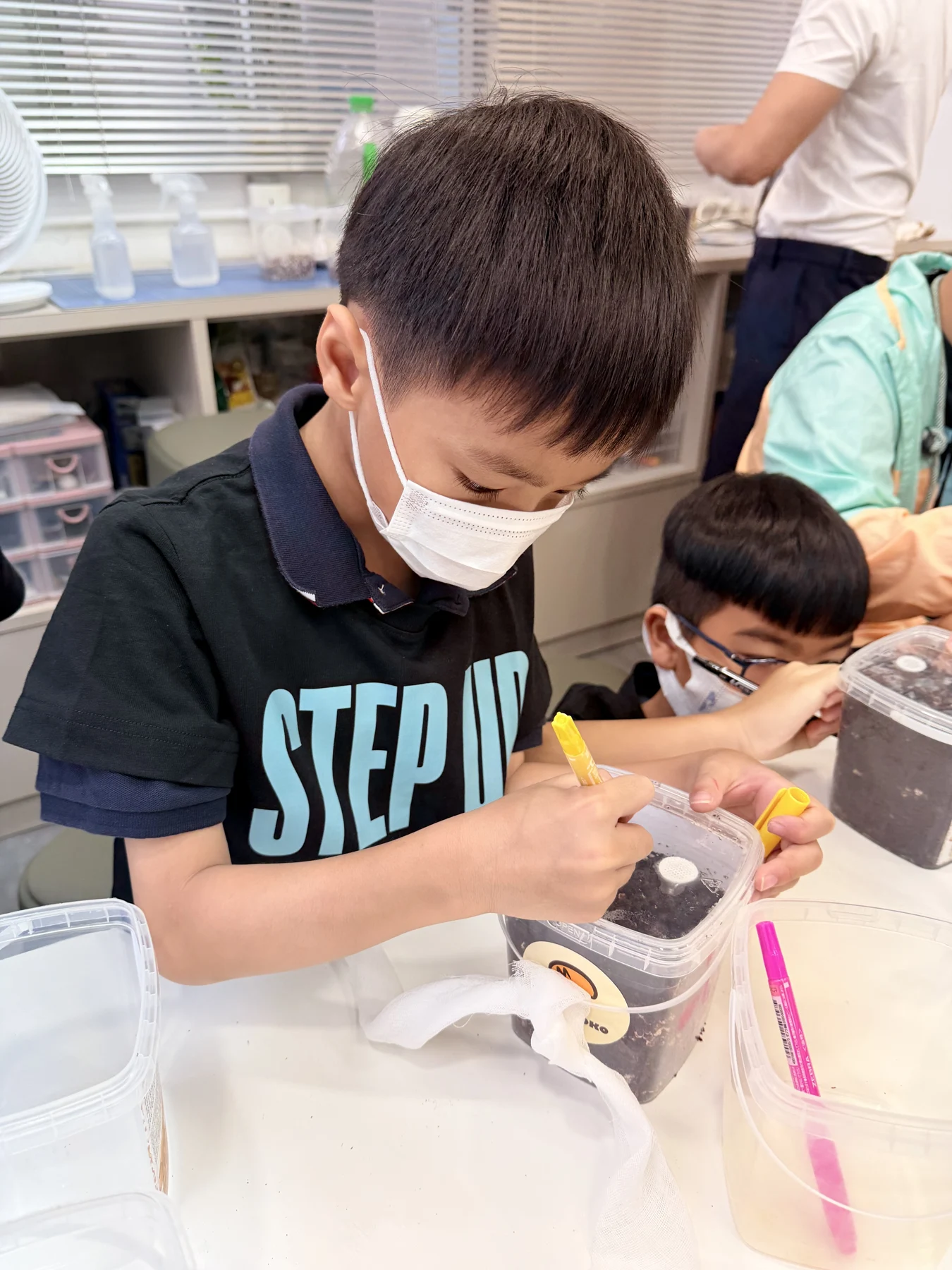 Students exploring mushroom growing and preparing take-home kits at Myconoko Lab