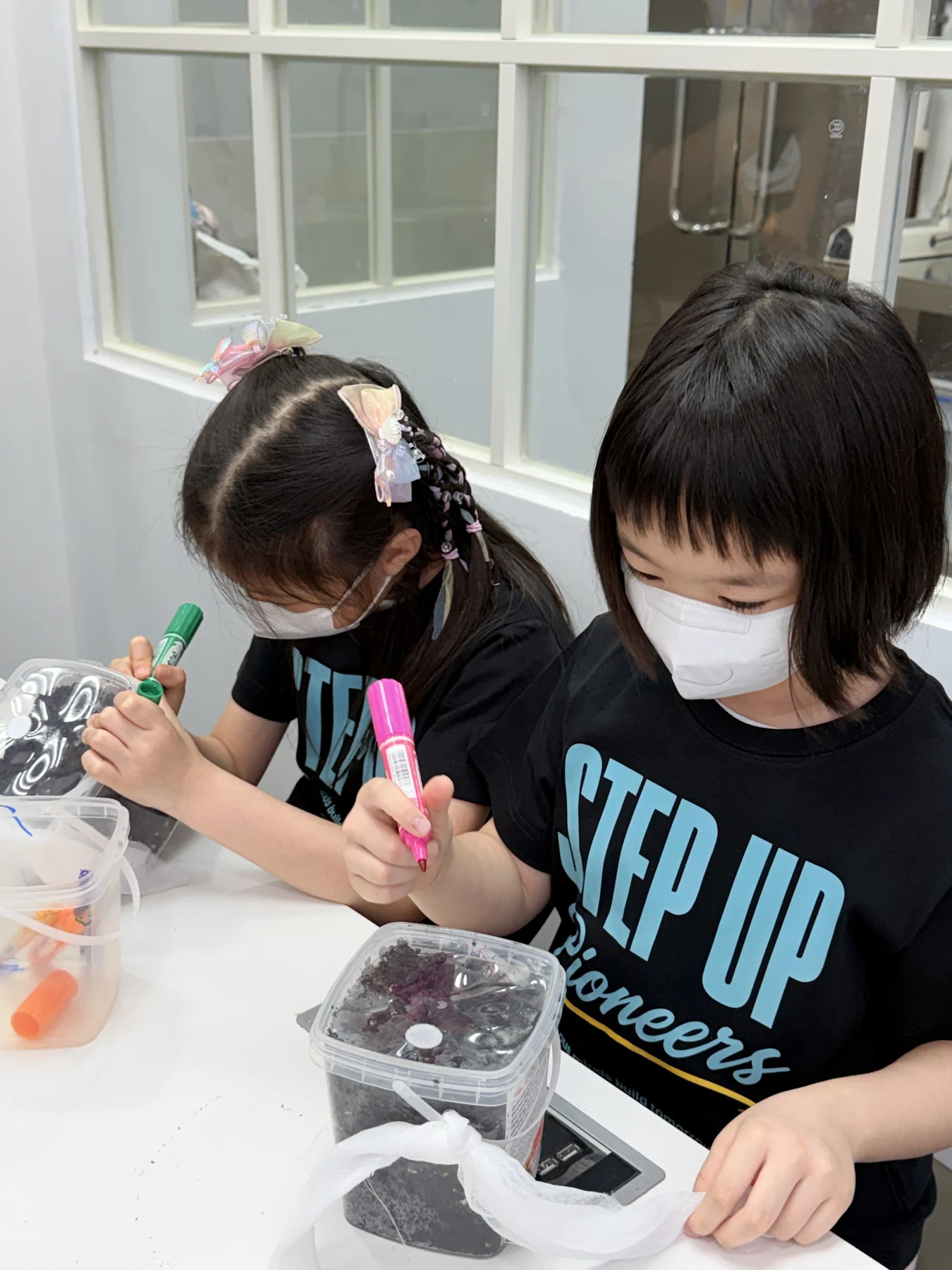 Students exploring mushroom growing and preparing take-home kits at Myconoko Lab
