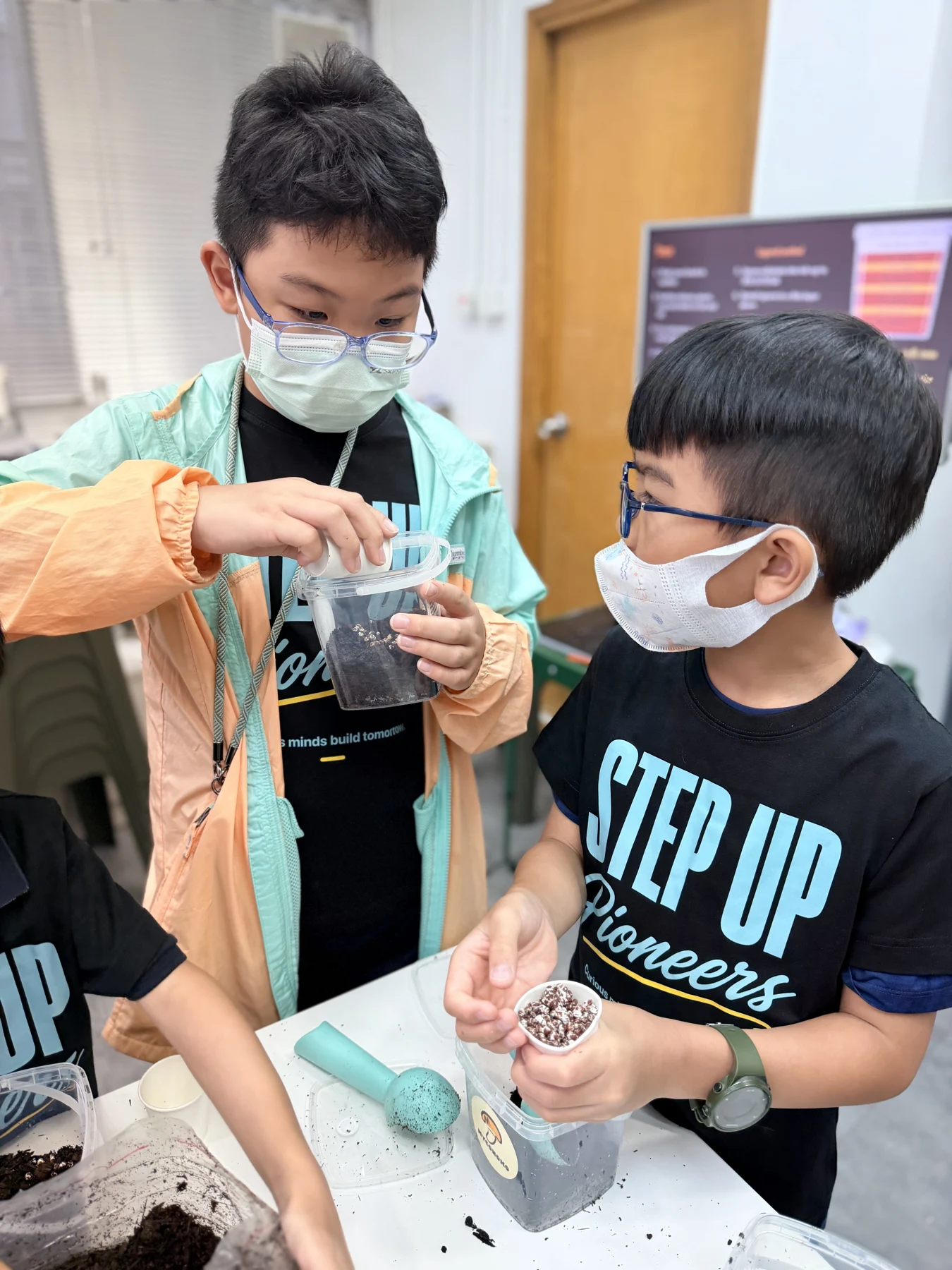Students exploring mushroom growing and preparing take-home kits at Myconoko Lab