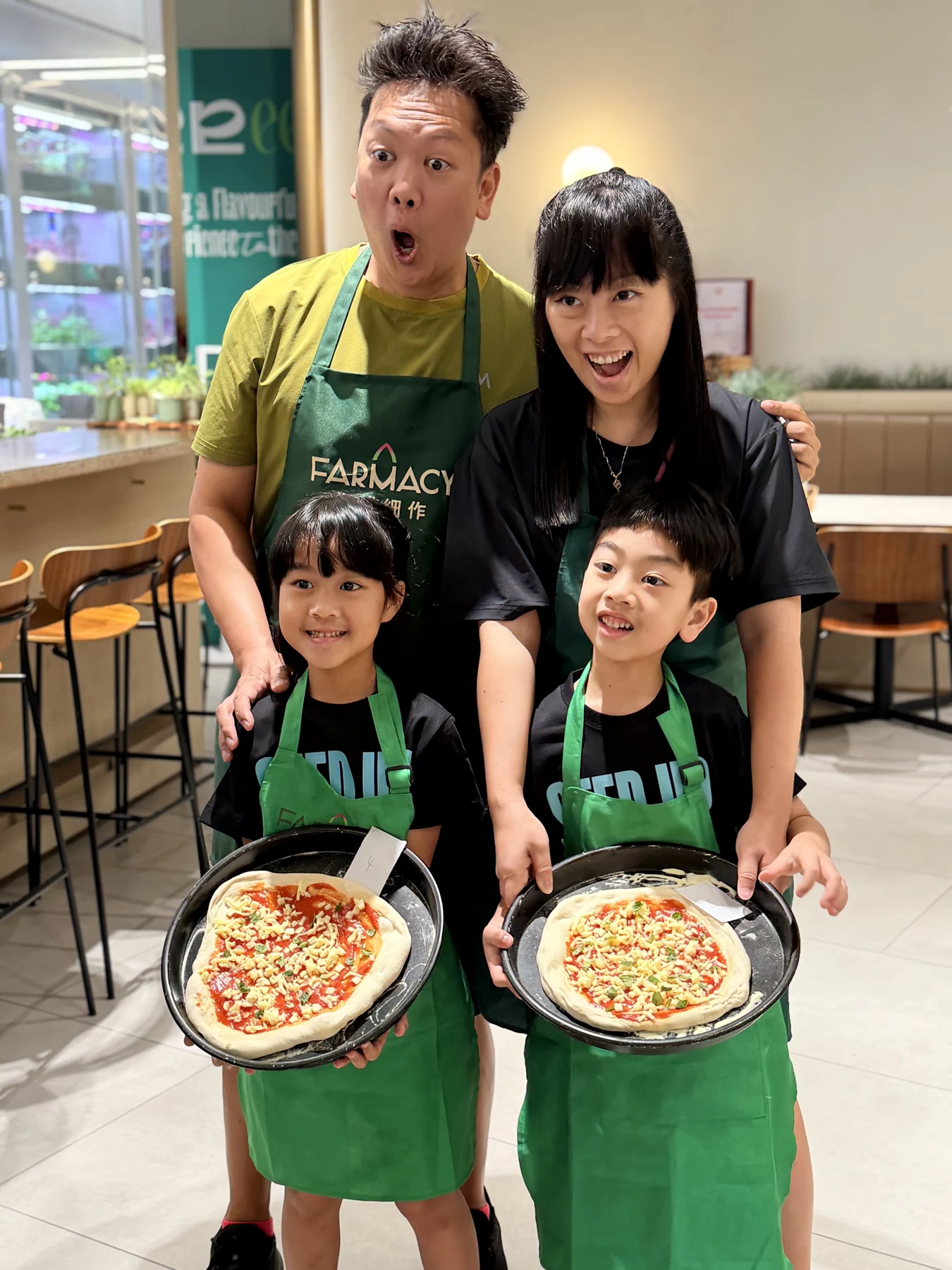 Families preparing or sharing their pizzas at SEED by Farmacy