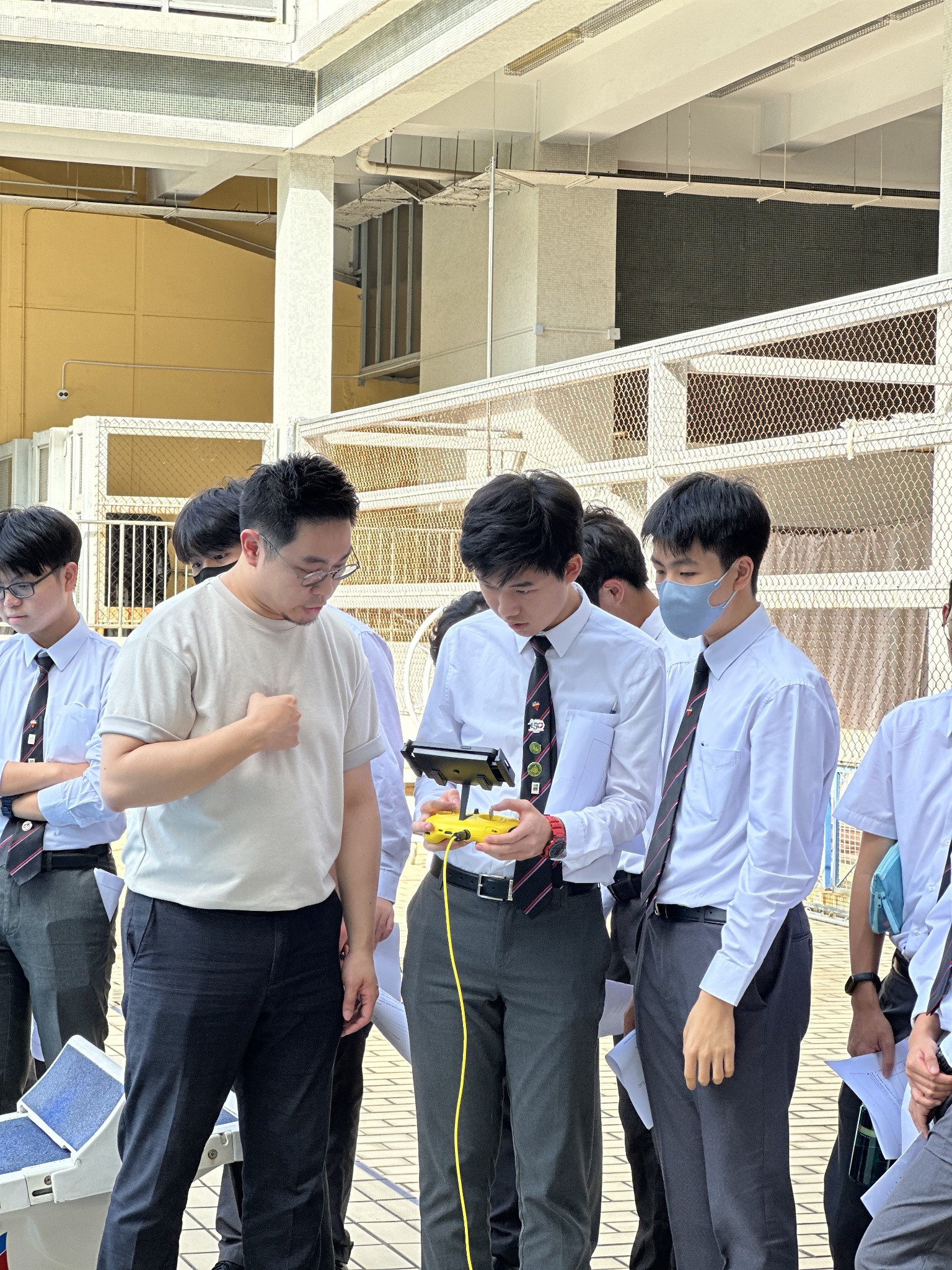 Students exploring technology equipment with an instructor