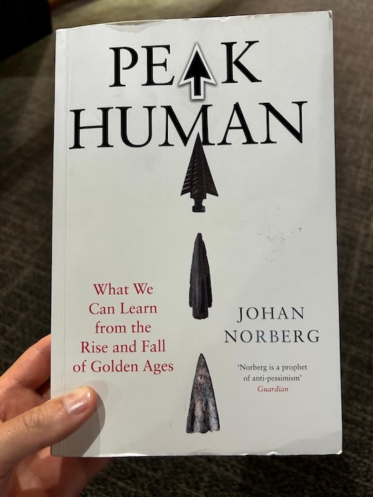 Person holding the book "Peak Human" by Johan Norberg.