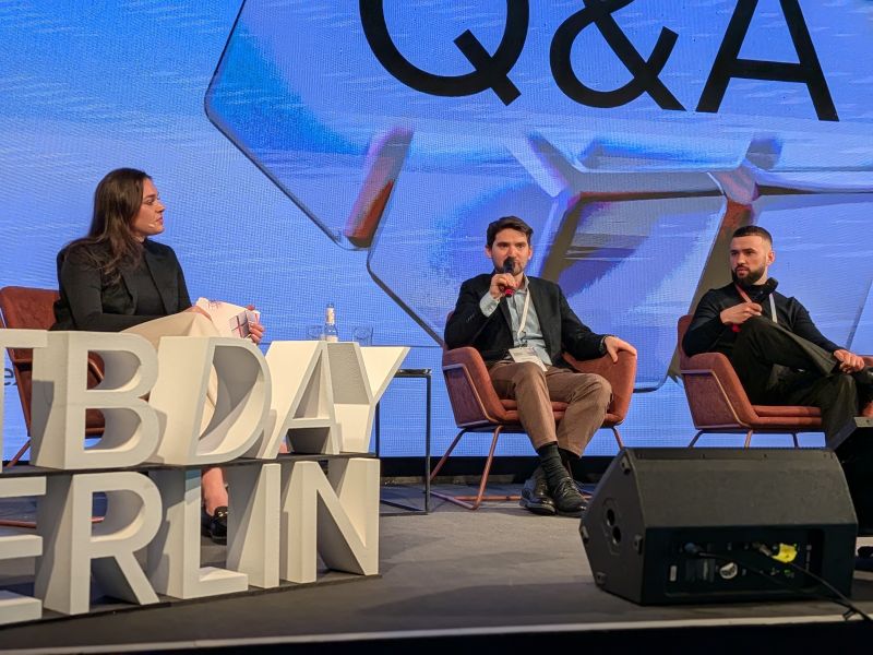 Three speakers discuss AI in marketing on stage during a Q&A at RTB House Day Berlin.