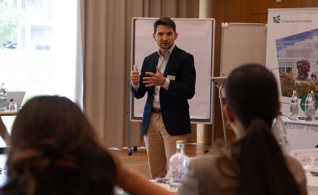 Giacomo Iotti speaking to an audience at the University of St Gallen about the AI-driven customer journey.