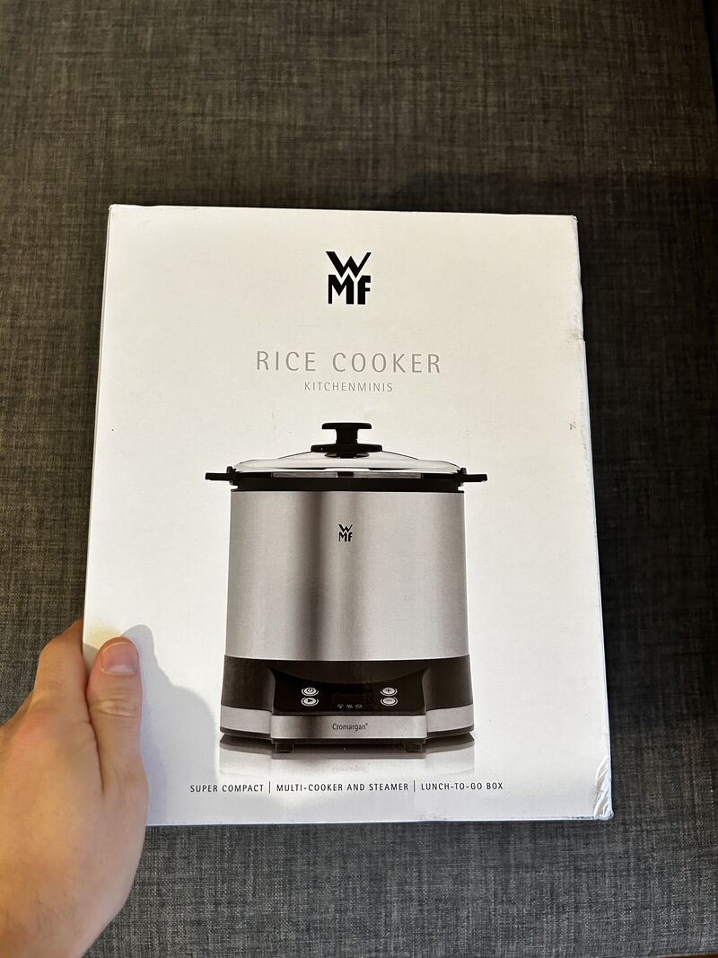 Hand holding a boxed WMF Kitchenminis rice cooker, bought as a Christmas gift through ChatGPT shopping.