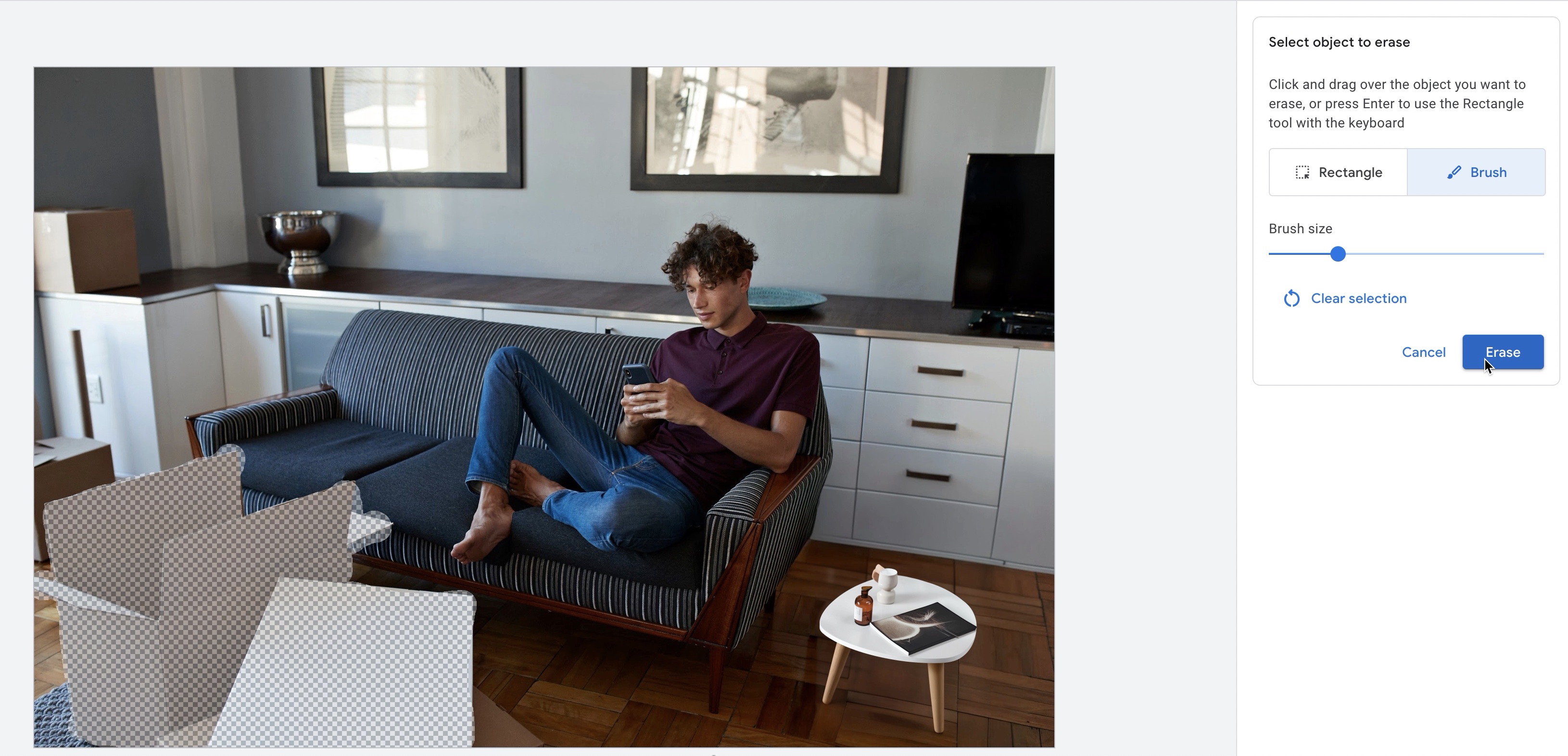 Google Ads' AI erase tool removes boxes from a living-room photo, leaving transparent selected areas.