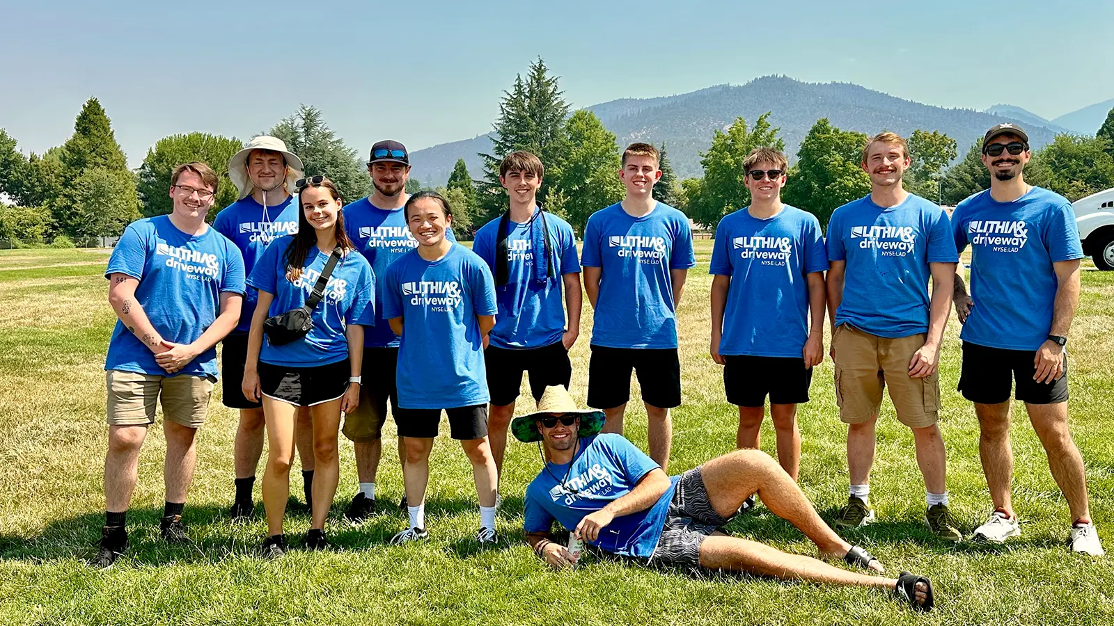 Interns from the Home Office in Medford standing on the grass 