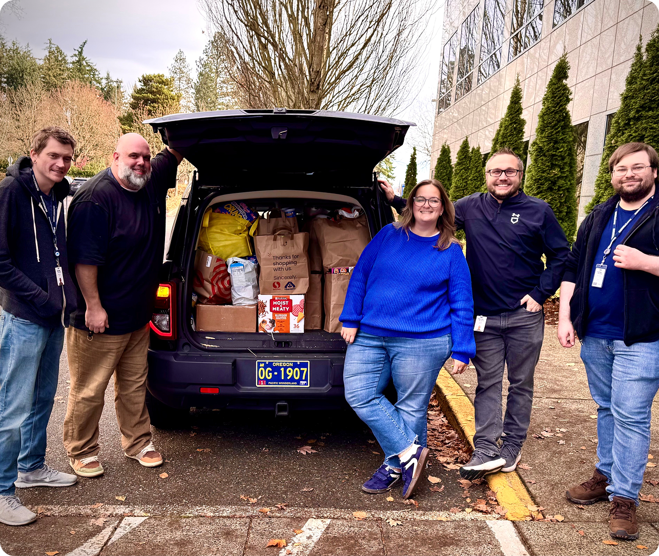 people standing in the MHO with food donations by the front desk 