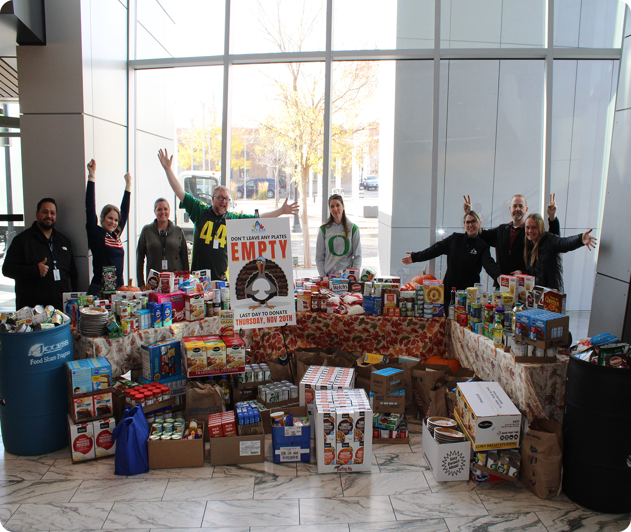 people standing in the MHO with food donations by the front 