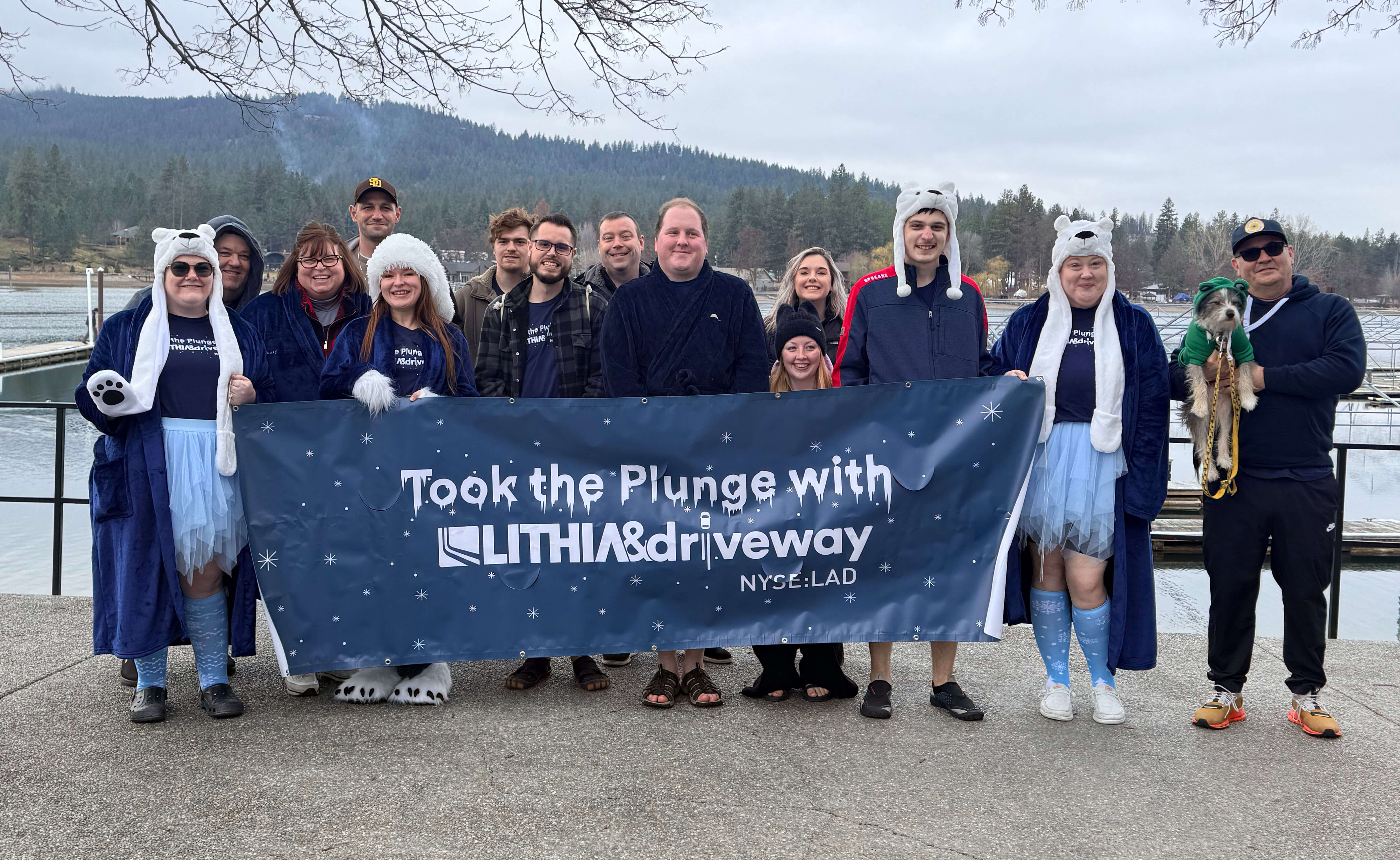 Group photo of Eugene Oregon Polar Plunge participants holding Lithia & Driveway banner