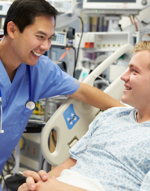 Doctor smiles while talking to an emergency room patient