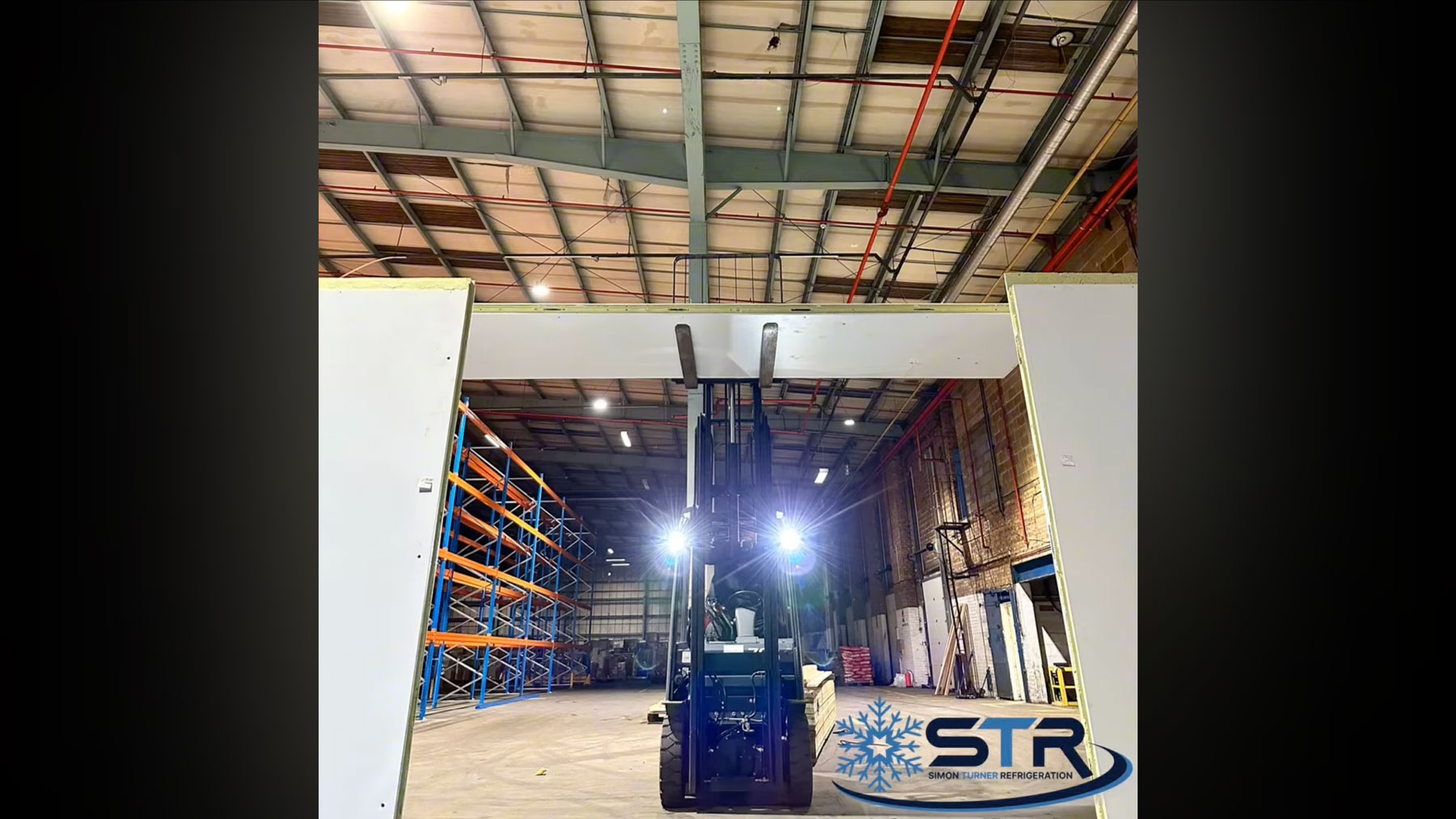 A forklift assembling the chiller room under construction