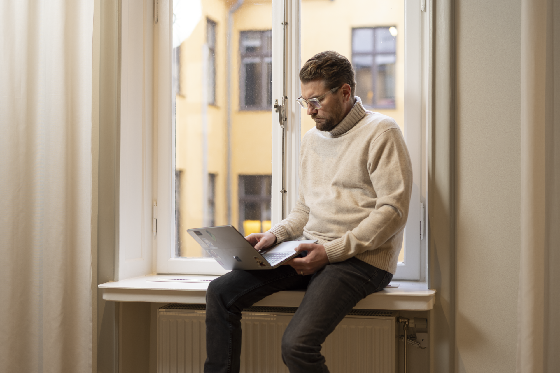 Risto Lavett, CEO at Redeploy sitting on top of the window frame