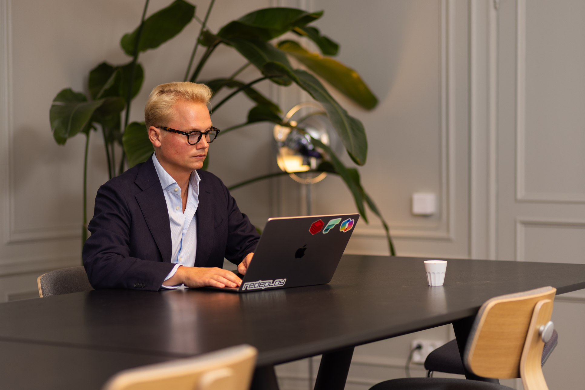 Oskar Dahl Aldeborn, AI Lead at Redeploy, working at his laptop in a meeting room at the Stockholm office