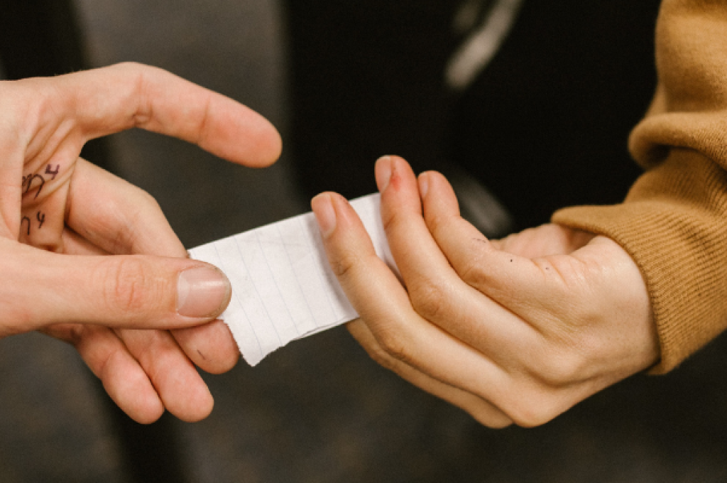 A cheat sheet passes hands.