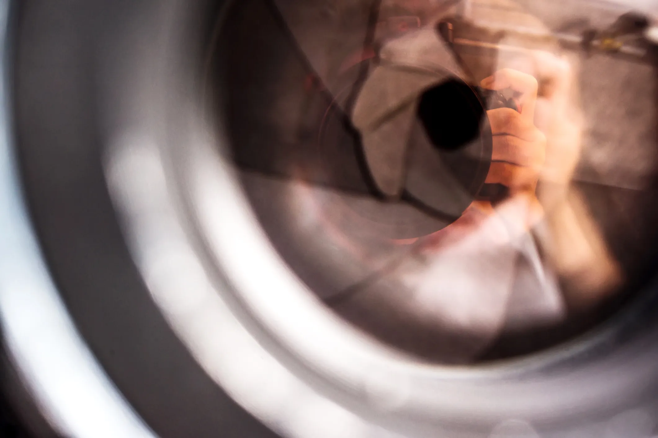 Photographer reflected through camera lens symbolizing executive visibility 