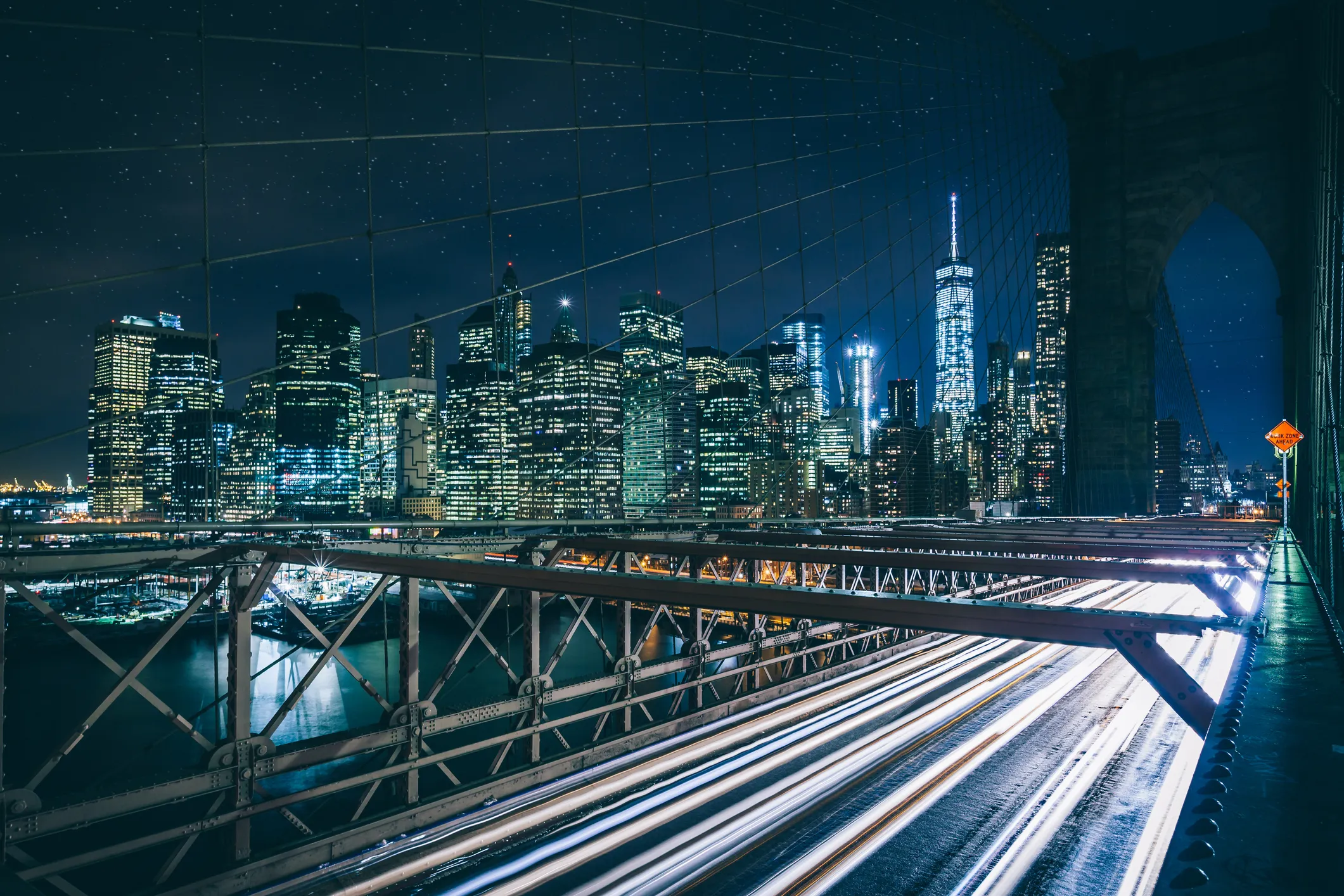 New York City skyline at night seen from the Brooklyn Bridge 