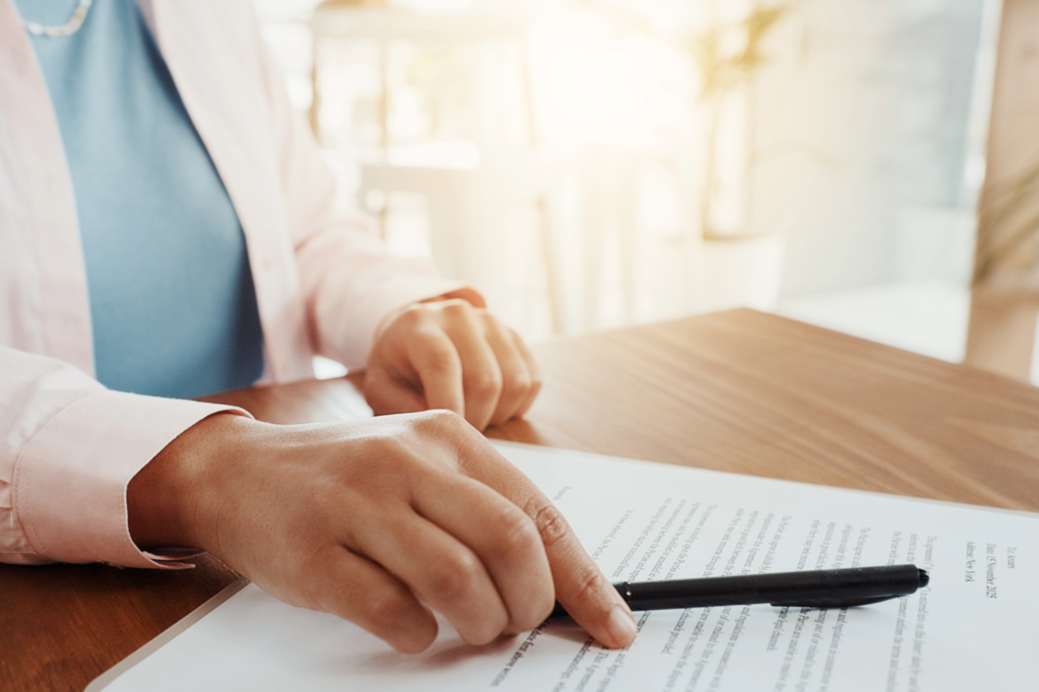 Person pointing at legal documents on a table, indicating construction lien services.