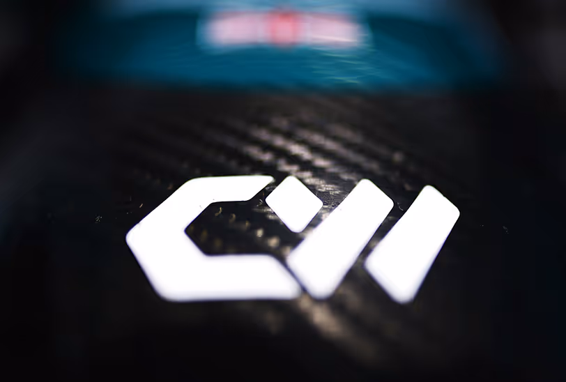Close-up of the CoreWeave logo displayed on the carbon fiber front nose of the Aston Martin Aramco Formula 1 car.