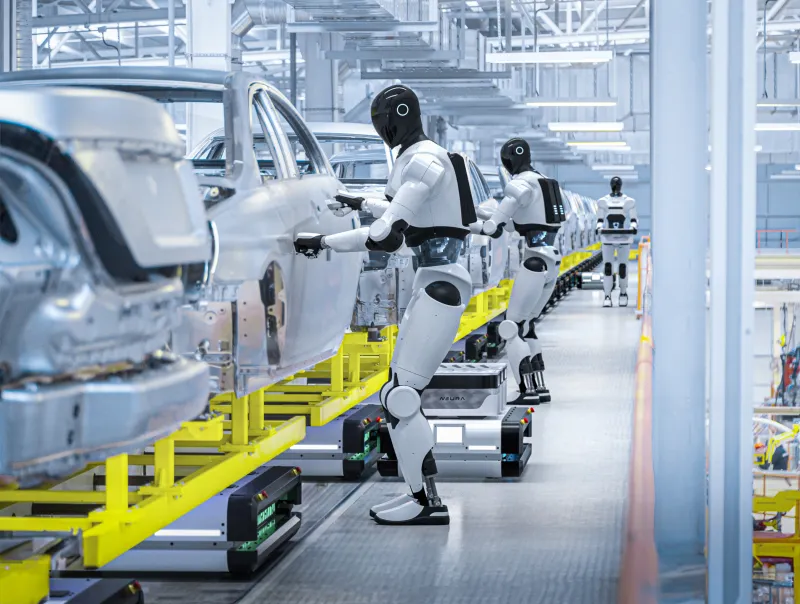 Neura robotic humanoid machines working on a car assembly line, assembling silver car bodies in a modern industrial factory setting with bright lighting and yellow support structures.