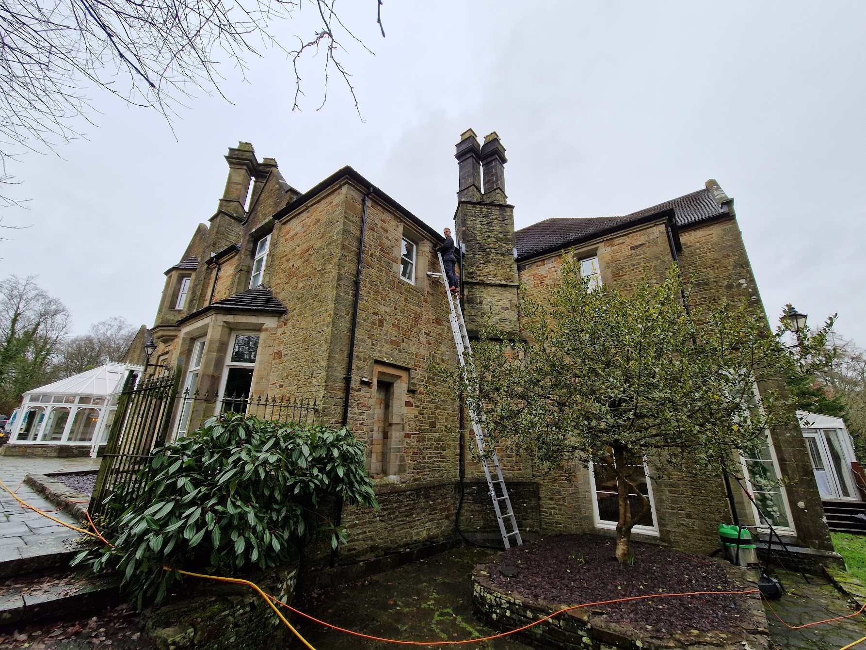 Eco Green cleaning the gutters of a large house in Bridgend