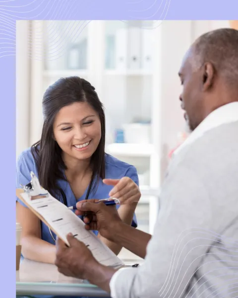 healthcare worker completing paperwork with patient