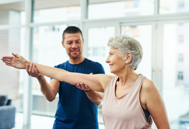Male physical therapist working with patient