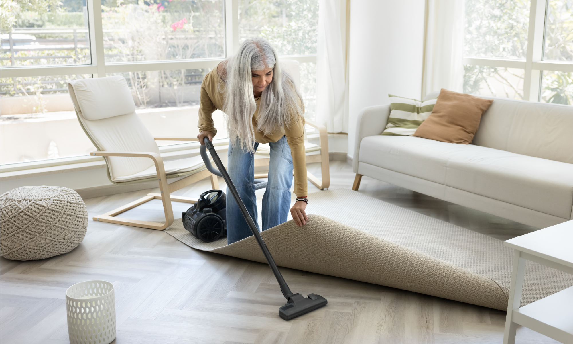 A woman vacuums with correct body mechanics