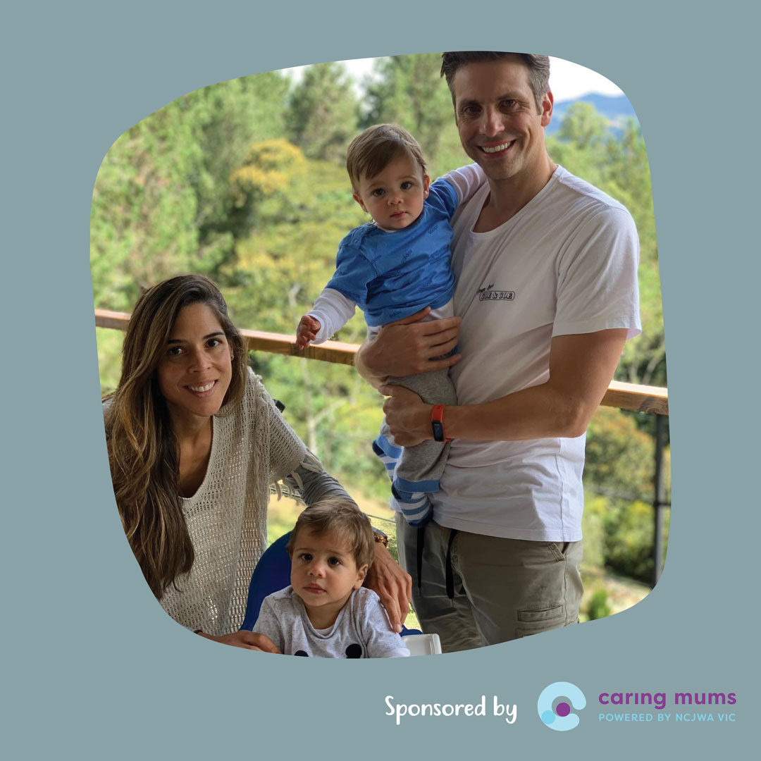 Maria, her partner and twin sons pose for a happy family photo together.