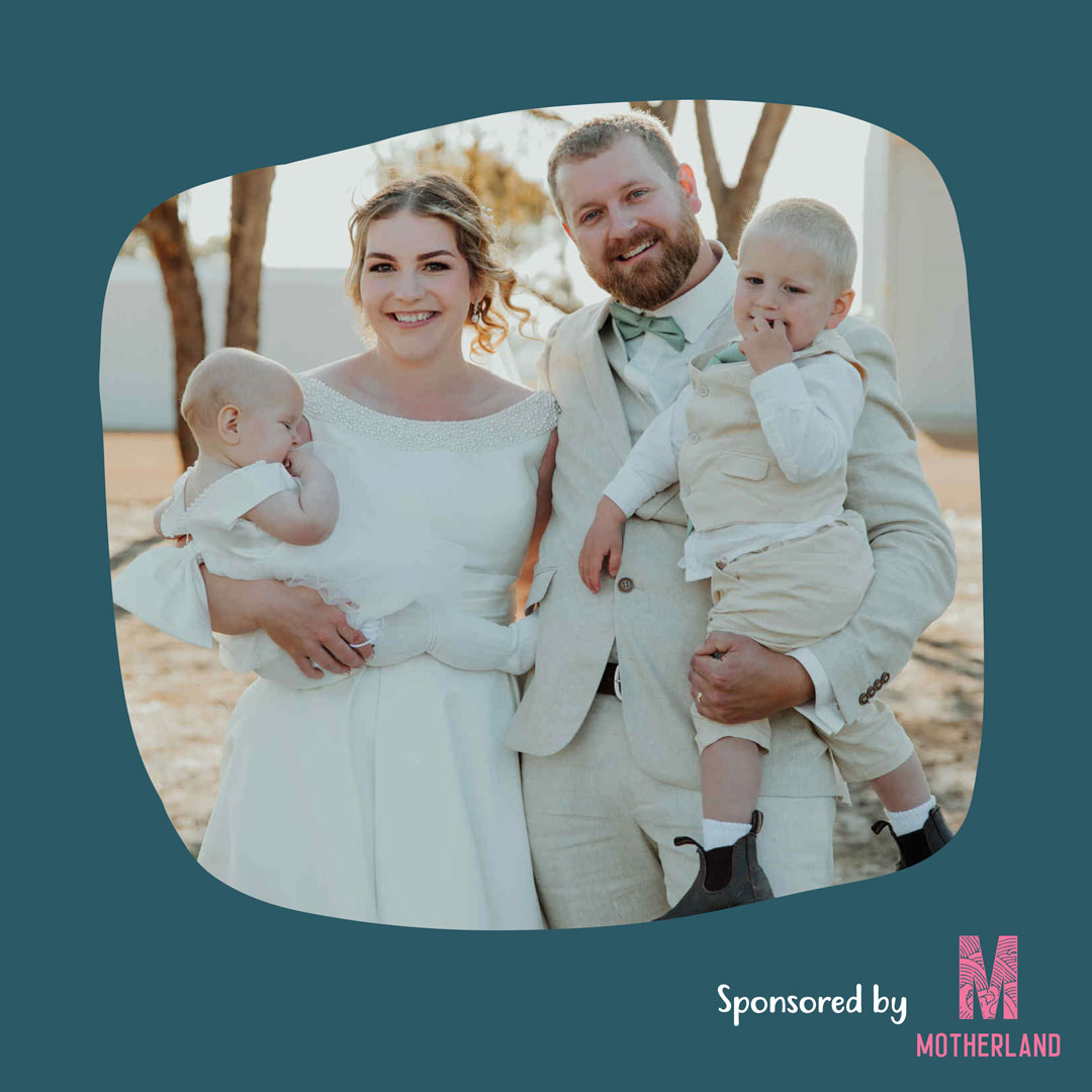 Laura poses for a photo with her husband and two children.